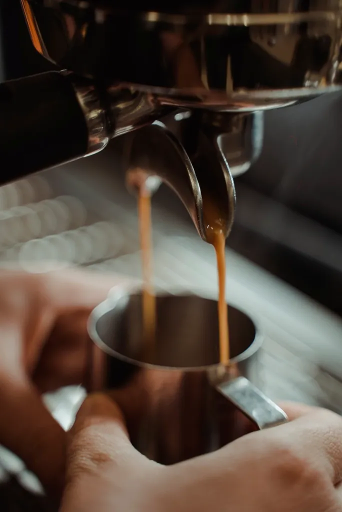 A barista pulling a shot behind the counter